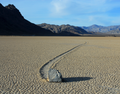 Desert landscape with a sliding rock and mountains in the background, unframed photograph